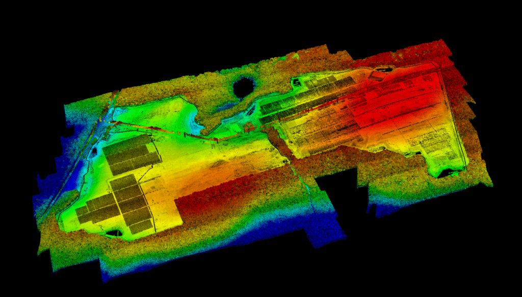 Height-colored LiDAR point cloud of a solar energy project under construction, captured using drone-based surveying.
